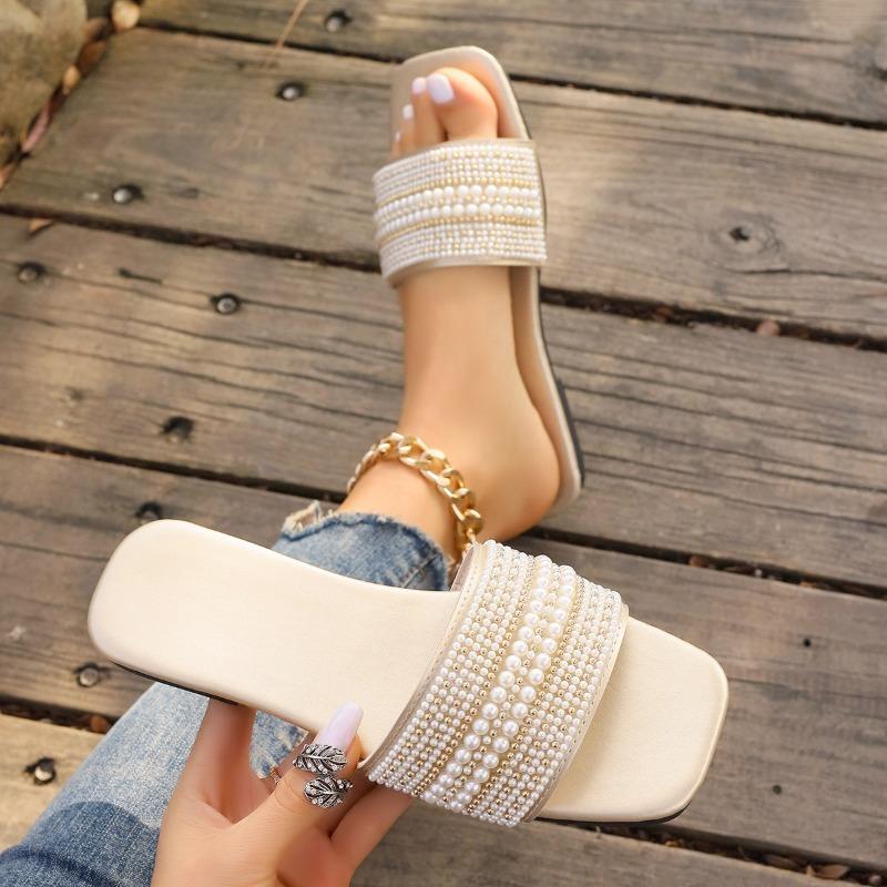 A Woman Wearing Square-toed Straight-line Rhinestone Flat Shoes and A Pair of Home Slippers