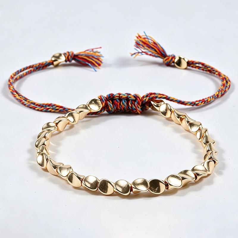 Handgemaakte Geweven Armband met Irreguliere Koperen Kralen en Creatief Kwastje Trekkoord