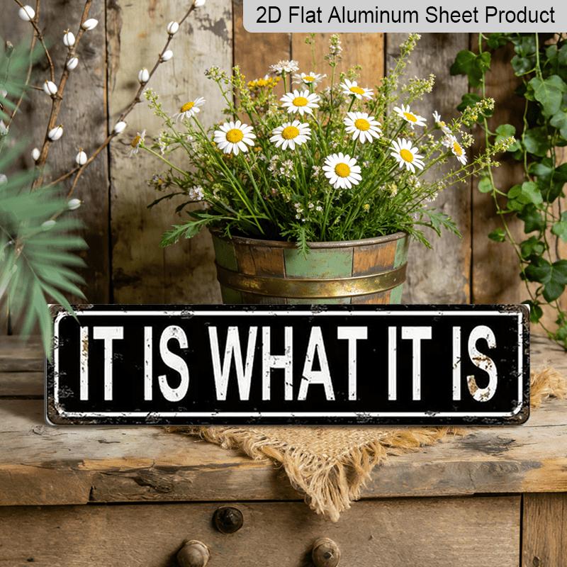 

Metal Sign Featuring The Phrase IT IS WHAT IT IS in A Rustic Style, Perfect for Vintage Wall Art in Your for Home, Garage, or Man Cave. This 40cm x 10cm