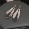 "Exquisite Metallic Leaf Drop Earrings: European & American Style, Trendy and Unique Design for Women."