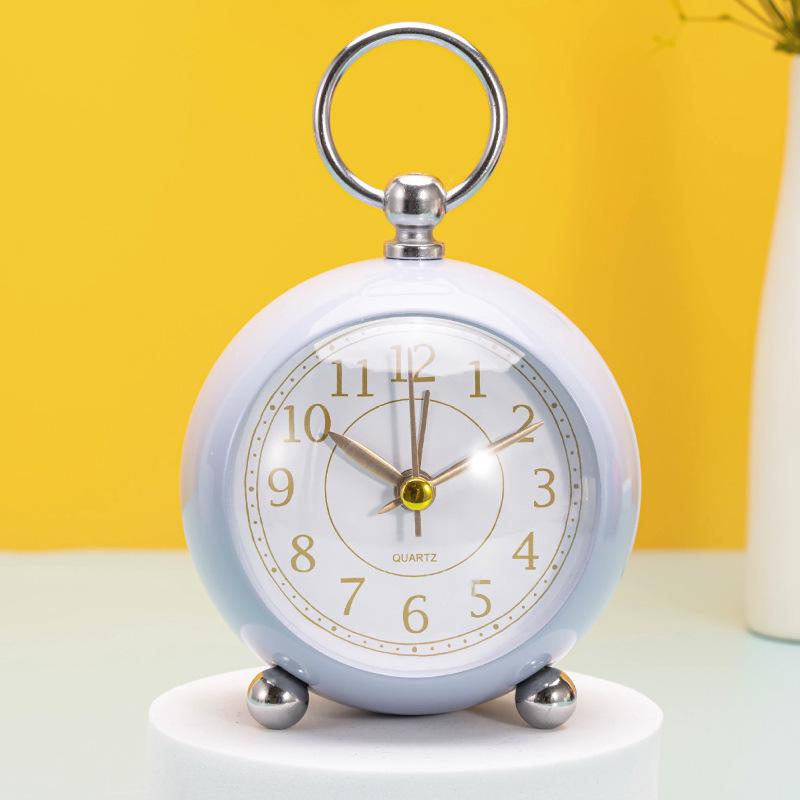Silent Metal Alarm Clock with Night Light and Gold Stamped Spherical Face - Perfect for Students and Children.