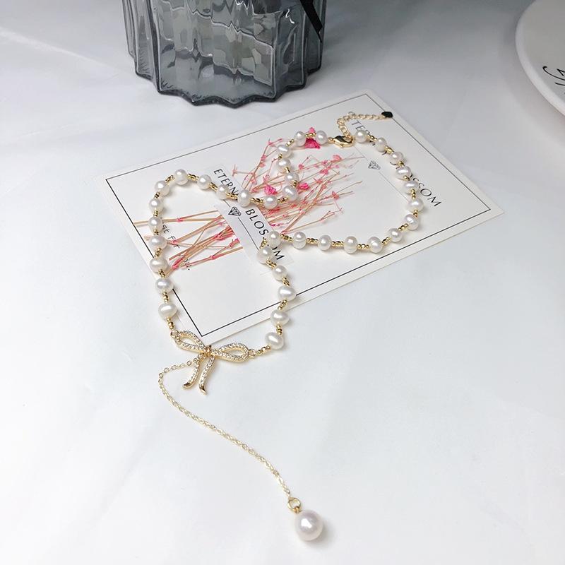 Elegant White Pearl Necklace with Bow Design and Spacer Beads