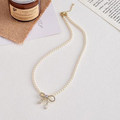 Naszyjnik z cyrkonowym kokardką i perłą - Elegancki lekko luksusowy dodatek jubilerski NS148