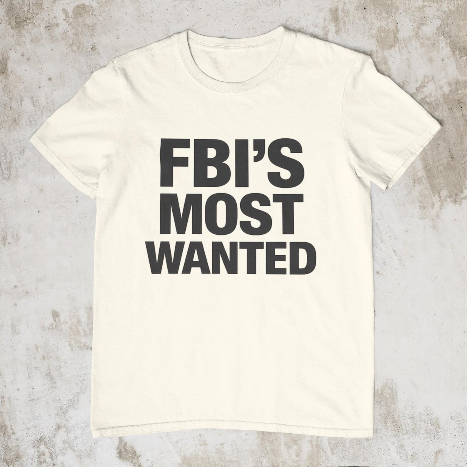 A FBIs Most Wanted Shirt – Funny Crime Meme Tee – Bold Typography Graphic Shirt – Humor Statement T-Shirt 2XL