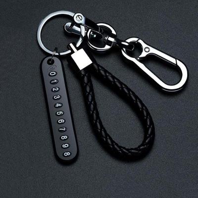 Porte-clés cordon en cuir pour homme avec étiquette de téléphone anti-perte en métal et pendentif de voiture en acier inoxydable.