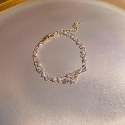 Trendy Titanium Steel Double Pearl Bracelet with Zircon Flower Pendant - Exquisite Korean Women's Jewelry.