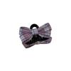 The Princess with The Checkered Bow Accessory Has A Chic Patterned Beak Hairpin At The Back of Her Head and A Hairclip.