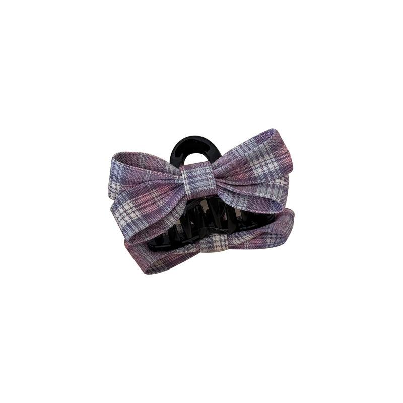 The Princess with The Checkered Bow Accessory Has A Chic Patterned Beak Hairpin At The Back of Her Head and A Hairclip.