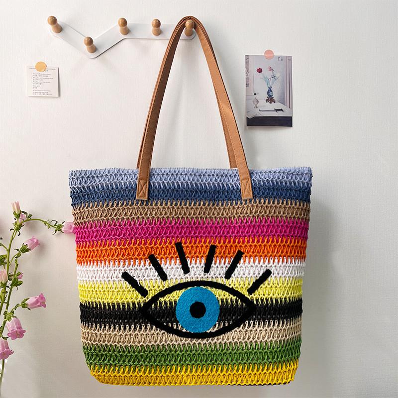 Große geflochtene Raffia-Strandtasche mit Augen-Print-Design und zwei Schultergurten für den Urlaub