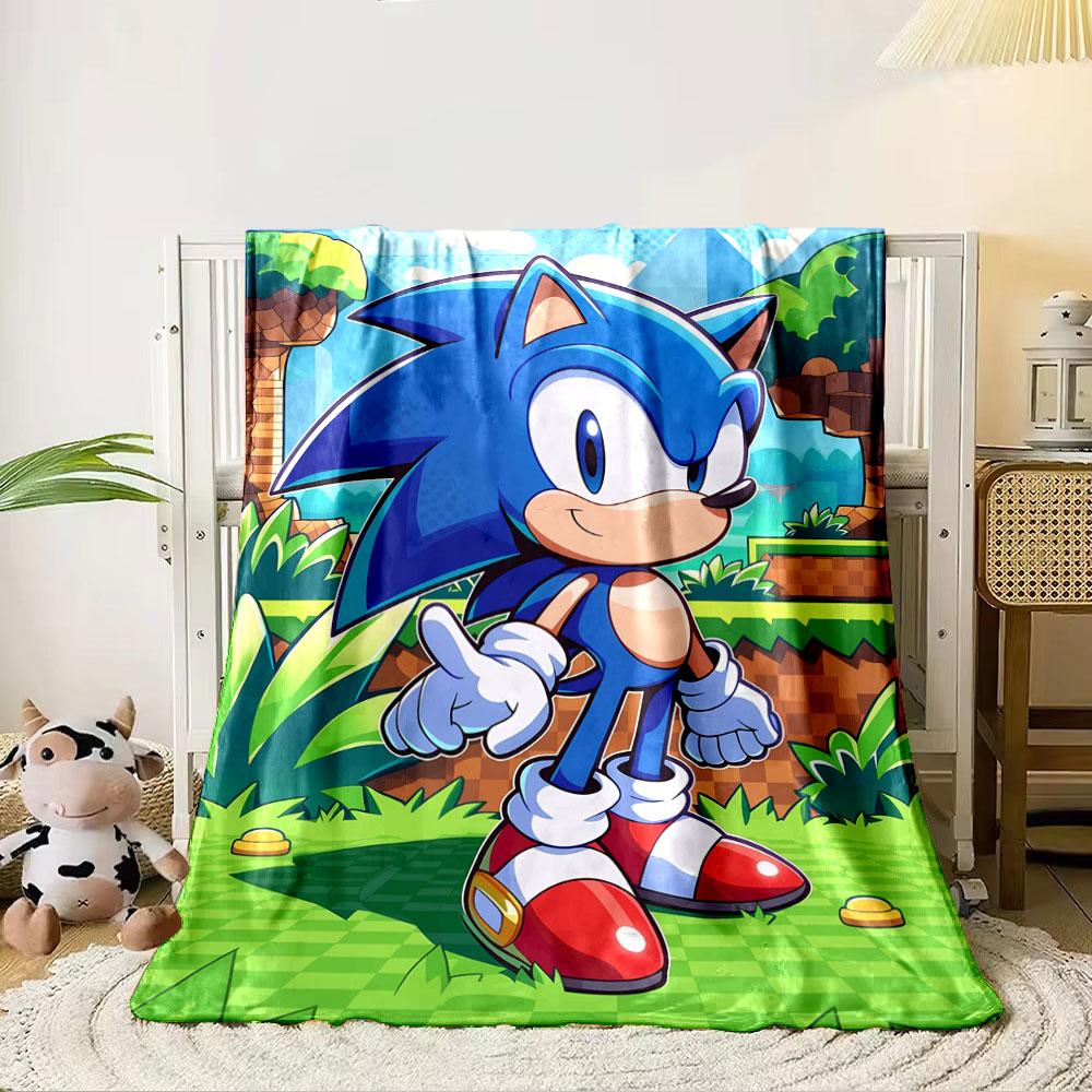 A blue cartoon hedgehog with red shoes stands in a grassy, blocky setting. for all seasons blanket lunch break throw gift 80cm x 120cm
