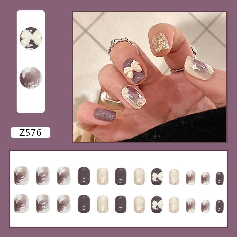 

Purple ins graffiti style Japanese temperament milky white bow diamond wearing nail piece