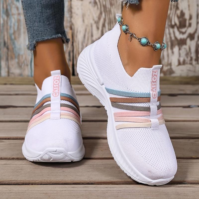 The Lady Wears Slip-On Casual Sports Shoes, Featuring a Breathable Mesh Design with Pastel Stripes, Suitable for Tennis And Comfortable