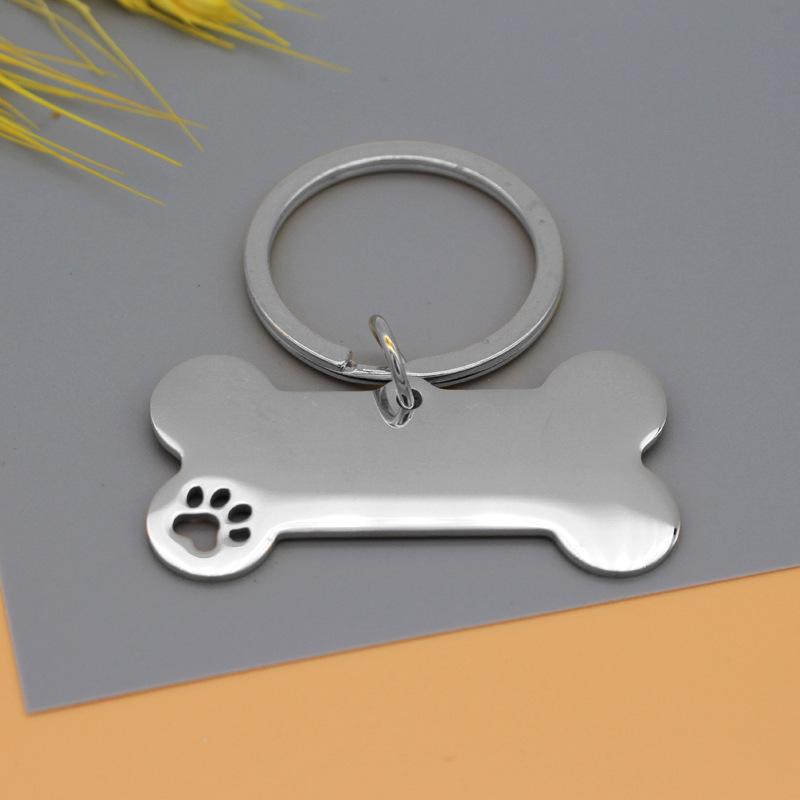 Hundemarke aus Edelstahl mit lasergraviertem Pfotenabdruck- und Knochendesign zur Haustieridentifizierung