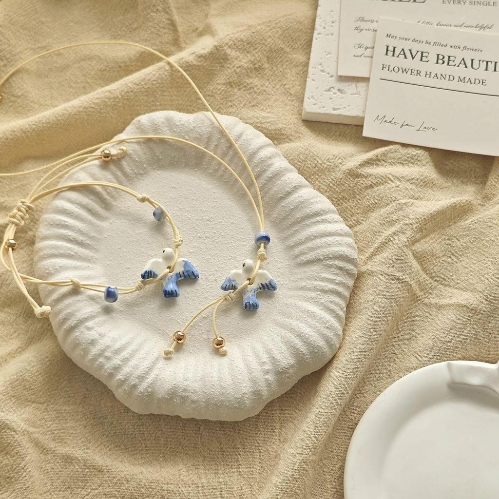 Artistic Small Blue & White Ceramic Bird Pendant Bracelet with Adjustable Woven Cord - Fresh Forest Style for Women