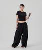AT THE MOMENT Double-Pleat Strap Balloon Elastic Pants_Black