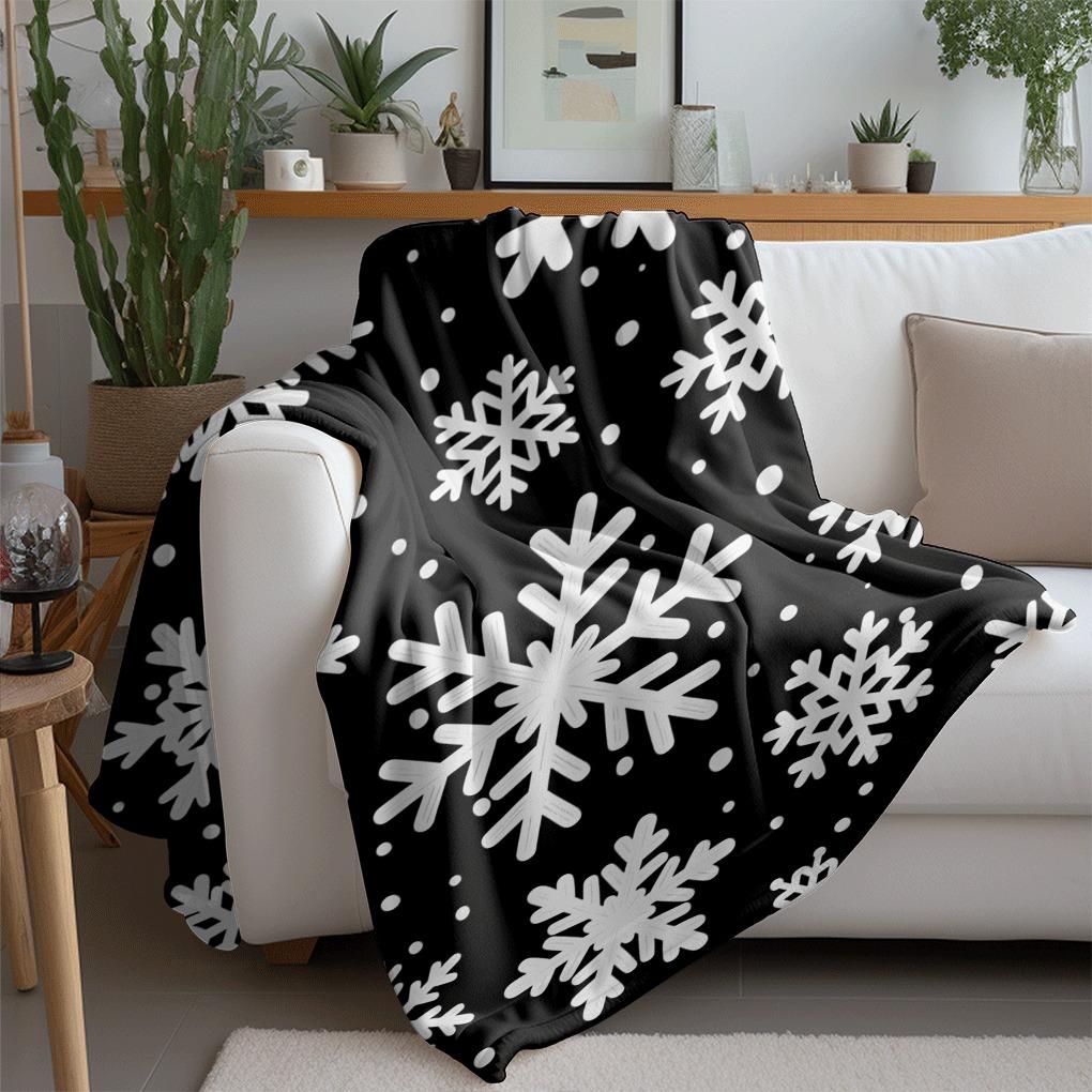 Black and white snowflake pattern printed flannel blanket, suitable for sofas, chairs, and bedrooms.