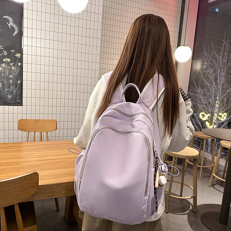 Casual solid color large-capacity schoolbag 2025 new versatile junior high school backpack college student travel backpack tide