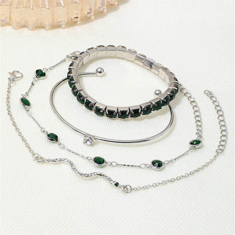 European & American Fashion Green Snake Diamond Bangle Set: Women's 4-Piece High-End Metal Jewelry with Elastic Design.