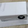 Best-Selling YG300 Yellow-White Mini Portable Projector with Mobile Screen Mirroring for Home Entertainment.