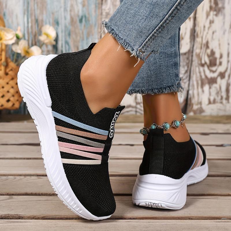 The Lady Wears Slip-On Casual Sports Shoes, Featuring a Breathable Mesh Design with Pastel Stripes, Suitable for Tennis And Comfortable