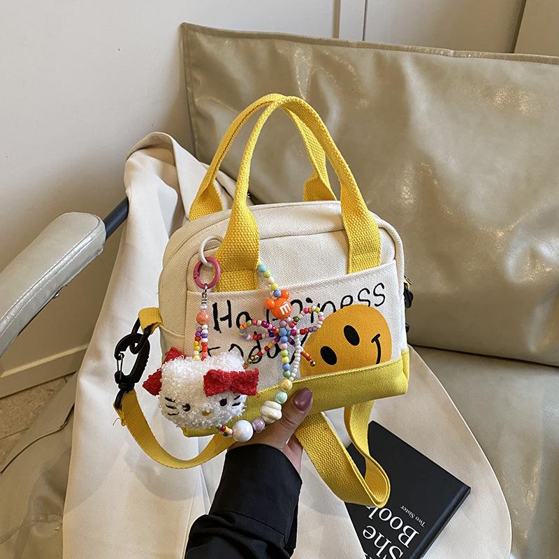 

Cute smiley girl handbag hand carry out high value canvas bag Korean version printed trend shoulder messenger bag Without pendant жёлтый