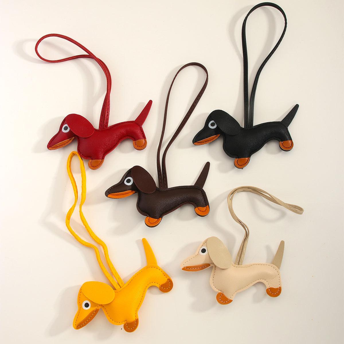 

New cartoon sausage puppy miu style PU leather bag hanging high-end bag pendant mobile phone leather pendant