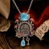 Mushroom Cottage Pendant Necklace with Dimensional Relief, Floral and Leaf Details, Blue Teardrop Dangle, and Vintage-Inspired Alloy Finish