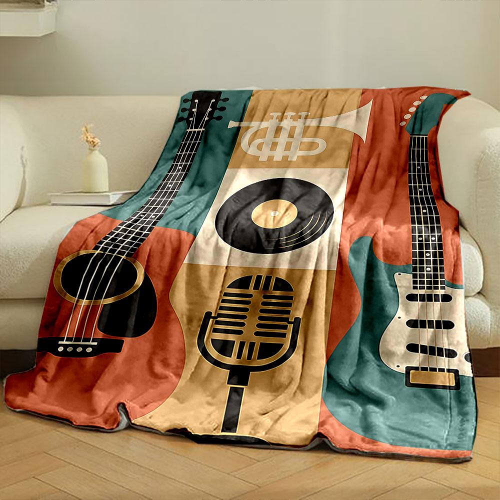 The pattern features guitars, a trumpet, a microphone, and a vinyl record. for all seasons blanket lunch break throw gift