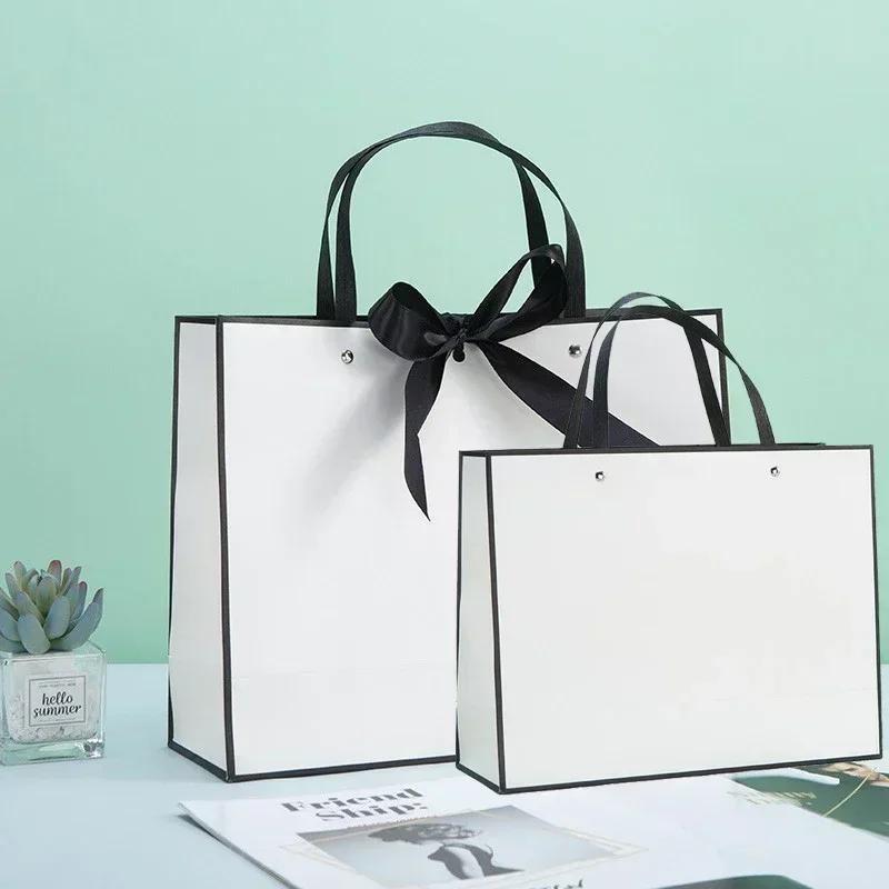 White Paper Jam Handbag Kraft Paper Thick Waterproof Frame Rivet Handle Gift Bag Cosmetic Clothing Store Portable Packaging Bags