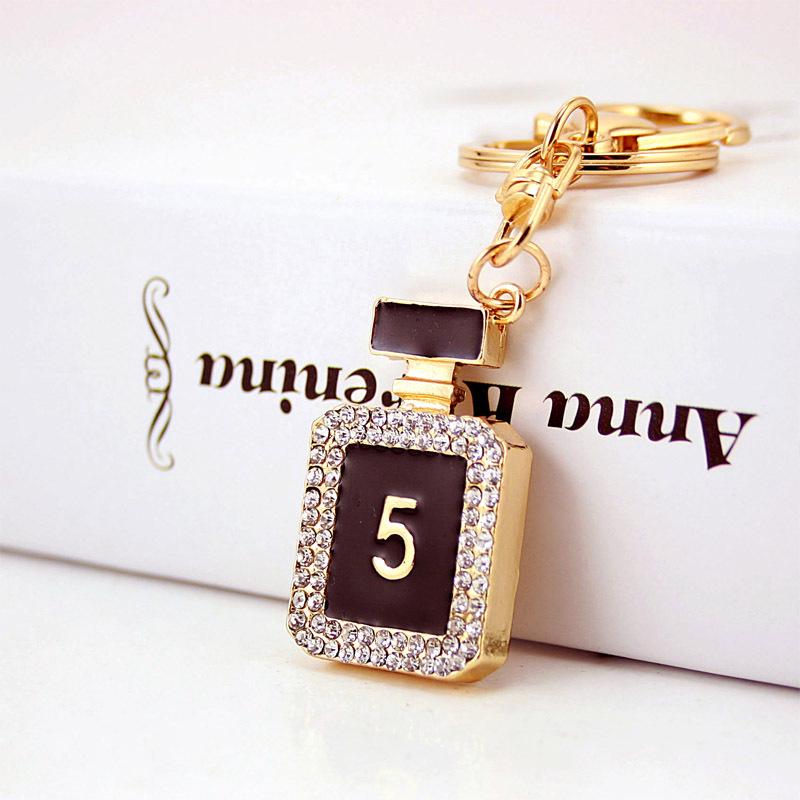 Elegant Diamond-Studded Four-Leaf Clover Keychain: Perfume Bottle Bag Charm for Women