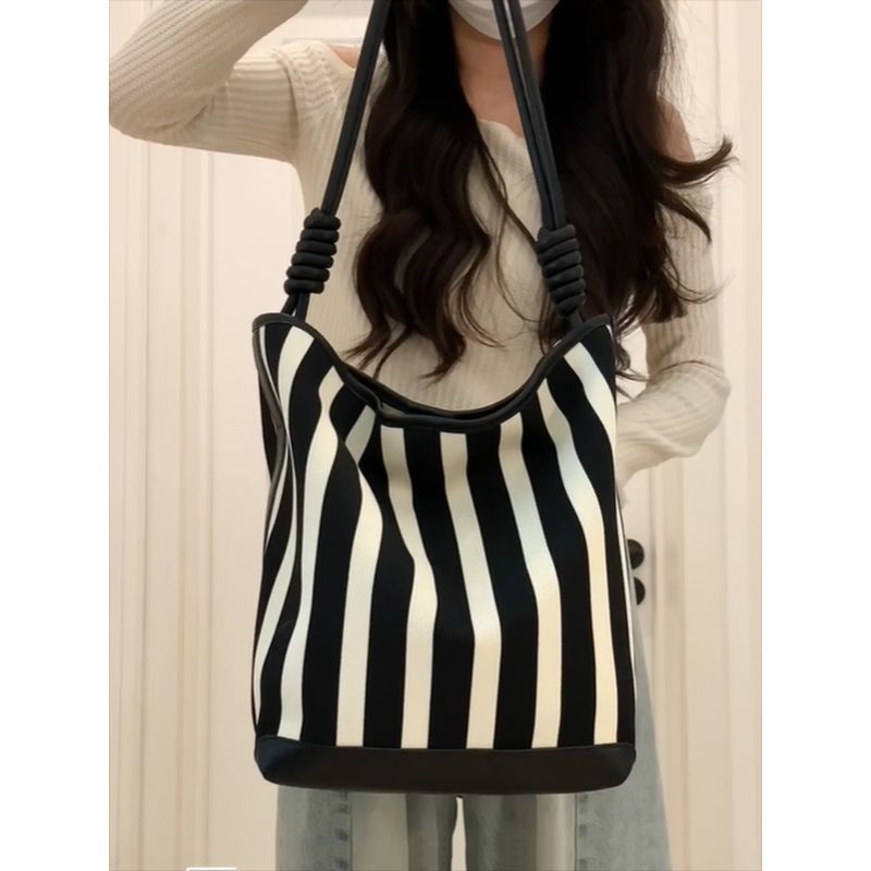 

Women s Bag 2025 New Large Capacity Contrast Color Stripe Canvas Bucket Bag High Sense Niche Shoulder Underarm Bag Black and white Stripes