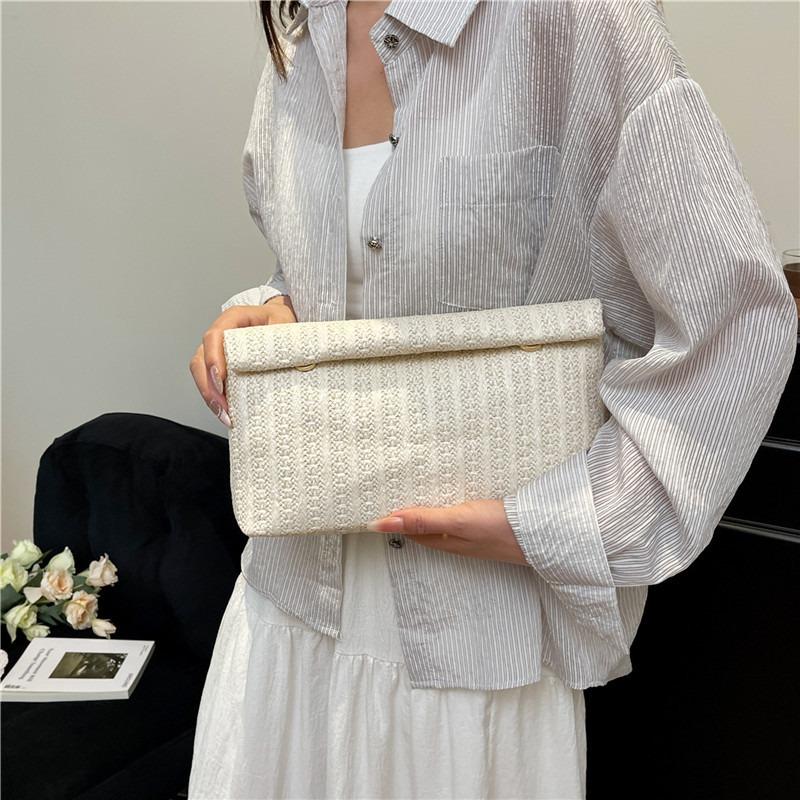 Large capacity new temperament fashionable design foreign style solid color straw woven texture hand envelope women's bag