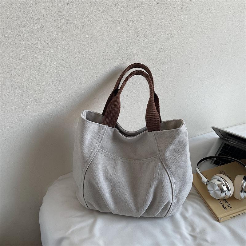 

2025 autumn new retro canvas portable small bag simple casual canvas bag women s Korean fashion hand bag