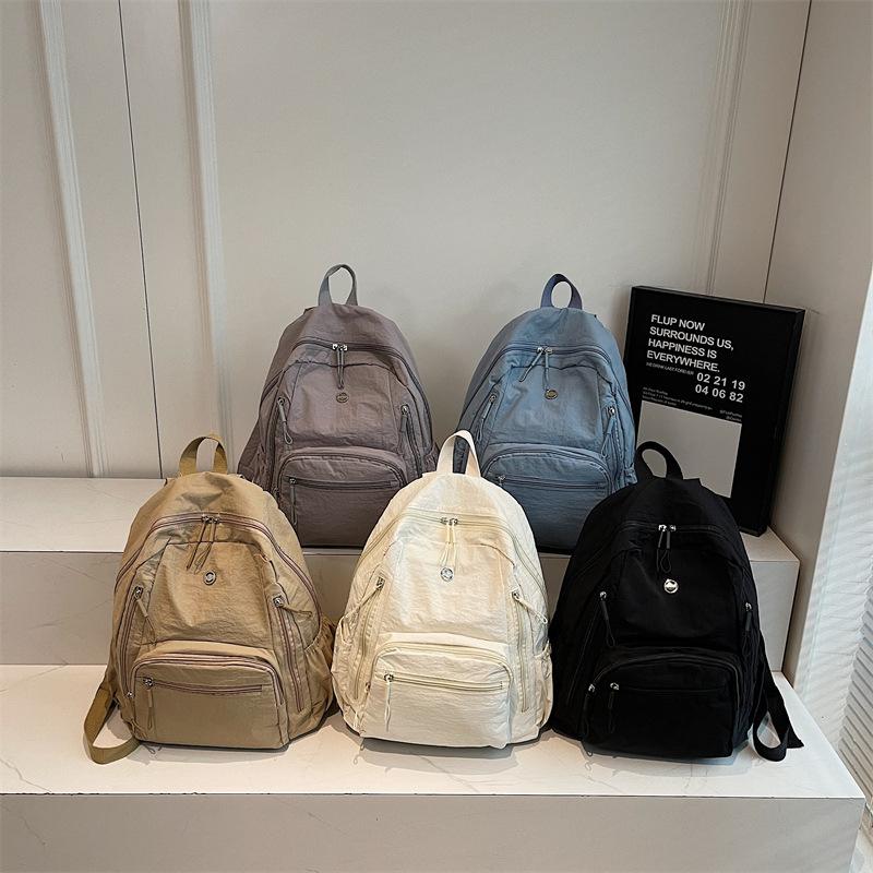 High-value solid color Korean version of the new popular simple fashion versatile light Japanese commuting travel backpack women