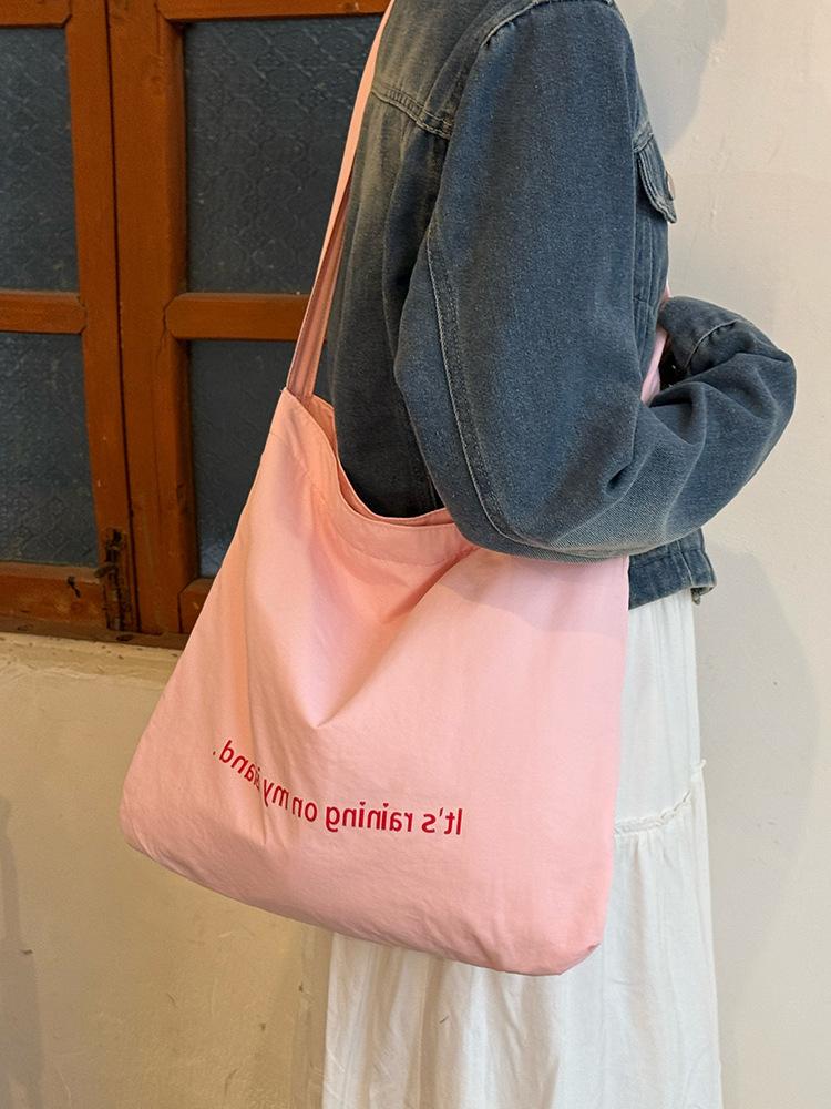 

Korean lazy wind double-sided letter canvas bag new large-capacity commuter tote bag niche shoulder messenger bag рожевий