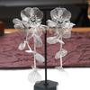 Silver Rhinestone Fishtail Tassel Earrings: Exaggerated Flower Design for a Stylish Look.