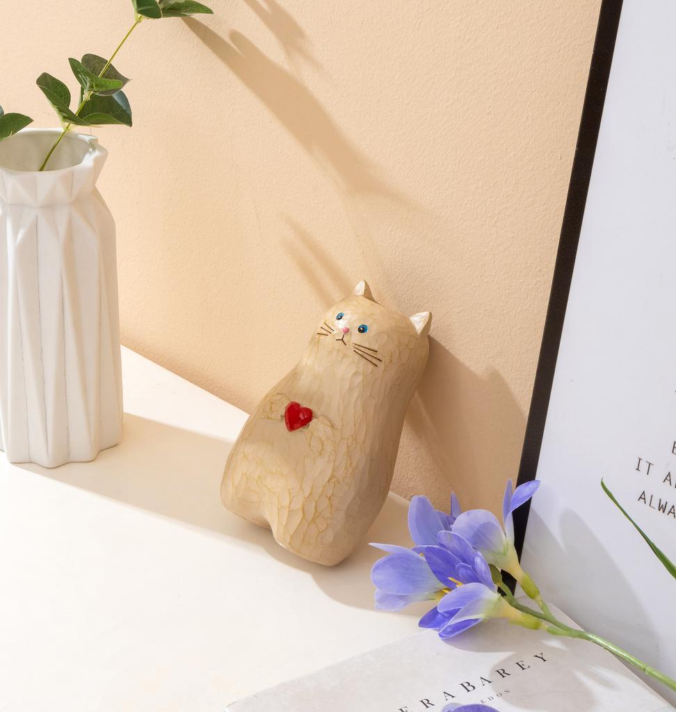 A cat shaped storage pen holder with heart-shaped decorative statues and multifunctional vase decorations