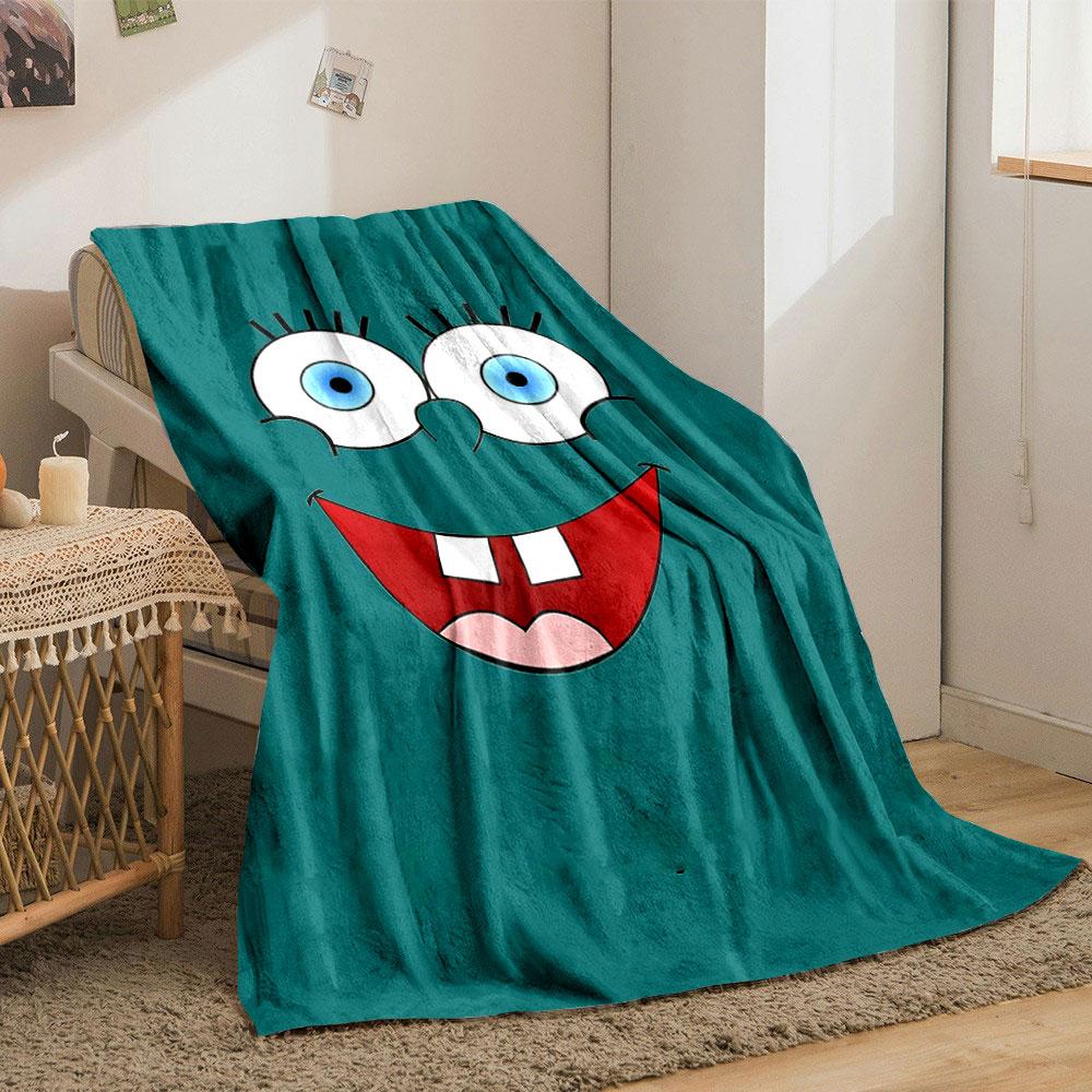 Bright cartoon face with large blue eyes, wide smile, and prominent teeth. for all seasons blanket lunch break throw gift