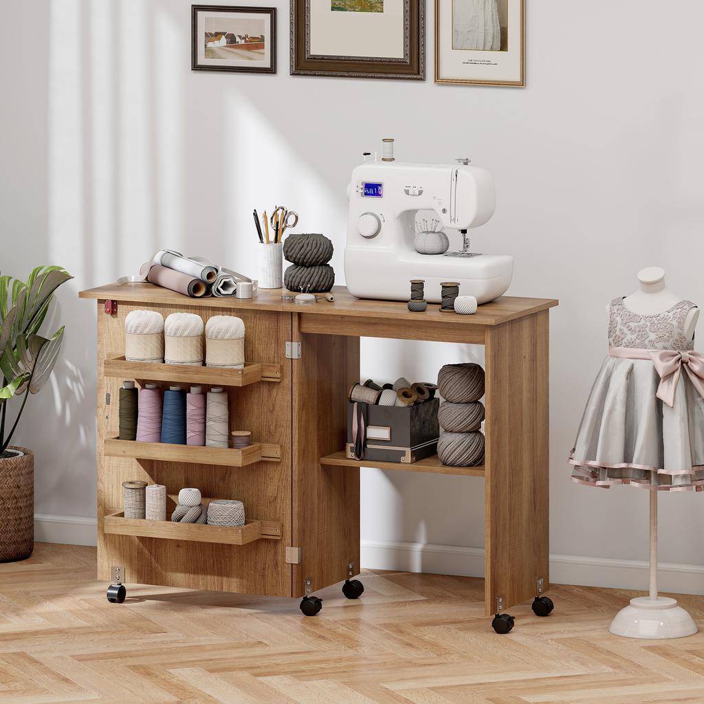 Folding sewing table, sewing furniture with drop-down leaf, storage bins, open shelf and casters, brown