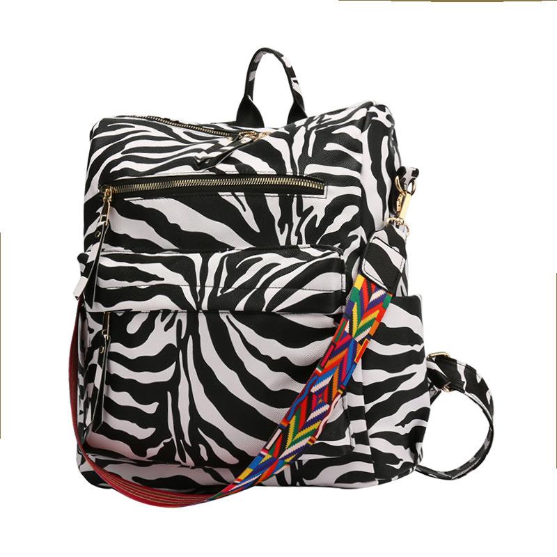 Neuer PU Retro Rucksack mit großer Kapazität für Reisen, Kuhmuster, schlichter britischer Stil, schräg über die Schulter tragbar, für Damen