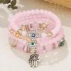 Bohemian Multi-layer Beaded Bracelet with Cross, Evil Eye, Palm Pendants, and Crystals.