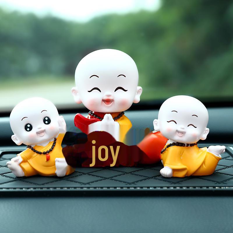Creative Little Monk Maitreya Buddha Car Ornament: Cute, Shaking Head Resin Doll for Car Interior Decoration and Safety.