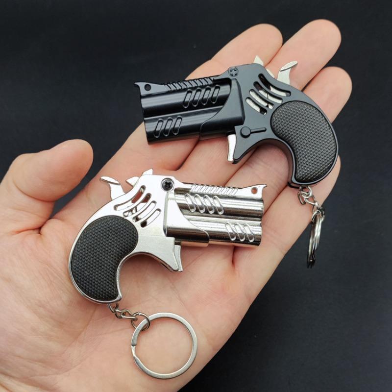 1Pcs Mini Keychain Metal Rubber Band Gun Game Toy Gun Launcher საბავშვო სიმულაციური პისტოლეტი სათამაშოები საჩუქრები საკიდი