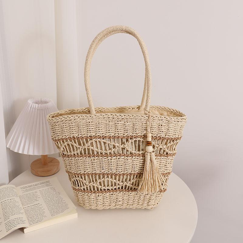 IELGY fashion hollow shoulder straw bag, fringed hand-woven holiday wind beach women's bag