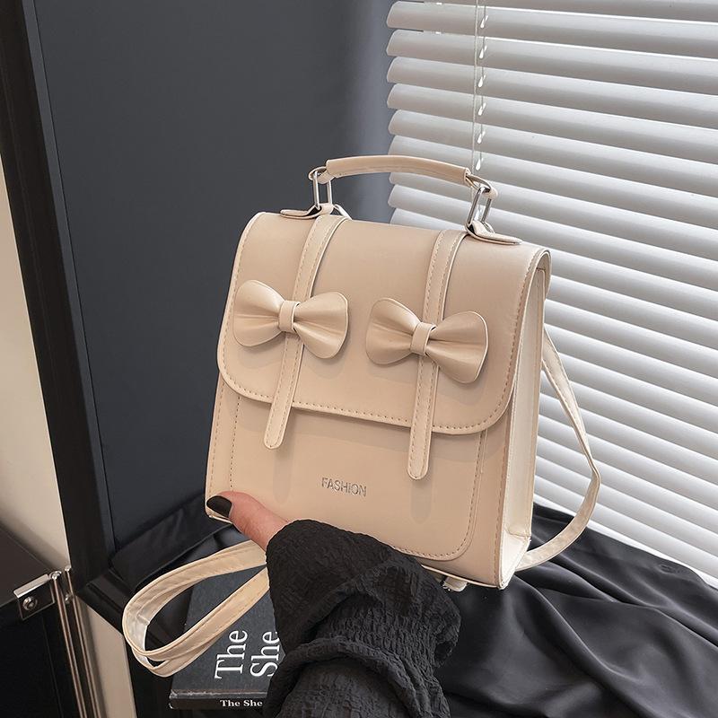 South Korea solid color college style commuter backpack women 2025 new trend bow portable shoulder messenger bag