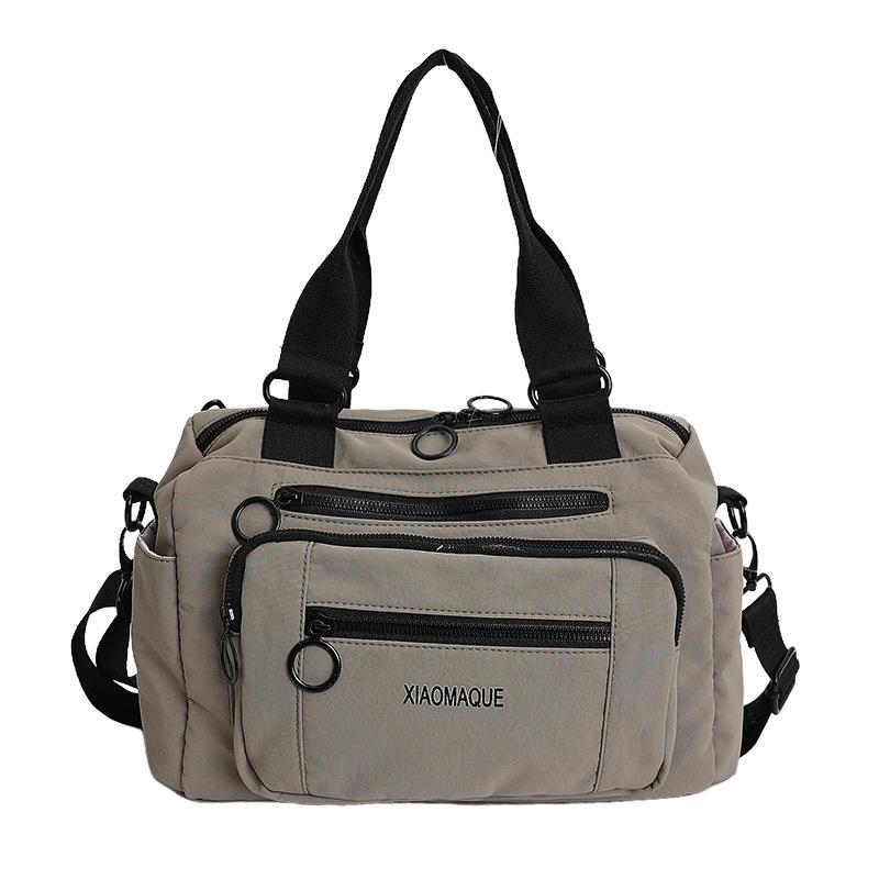 

Beige Compact Duffel Bag with Multiple Zippered Pockets and Dual Top Handles for Gym Travel or Daily Use зелёный