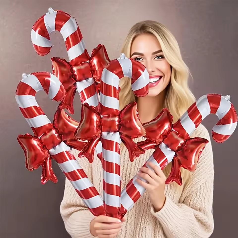 Christmas bows, candy canes, aluminum foil balloons with red and white stripes for a happy Christmas and New Year outfit