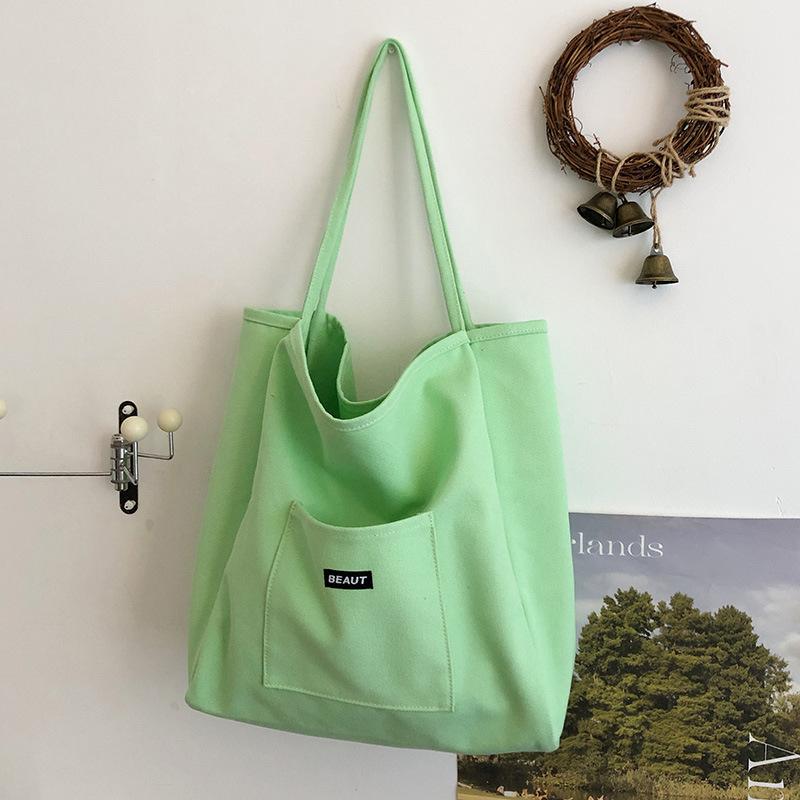 Bolsa de lona com letra de cor sólida 2026 nova ins grande capacidade simples moderna bolsa de ombro versão coreana bolsa tote artística