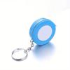 A Stylish Keychain Measuring Tape In Vibrant Colors, Featuring A 1.5-Meter Retractable Design, Perfect for Measuring Clothing Sizes