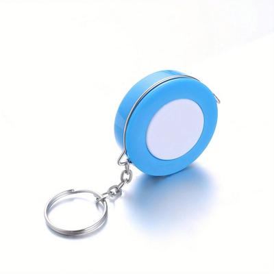 A Stylish Keychain Measuring Tape In Vibrant Colors, Featuring A 1.5-Meter Retractable Design, Perfect for Measuring Clothing Sizes